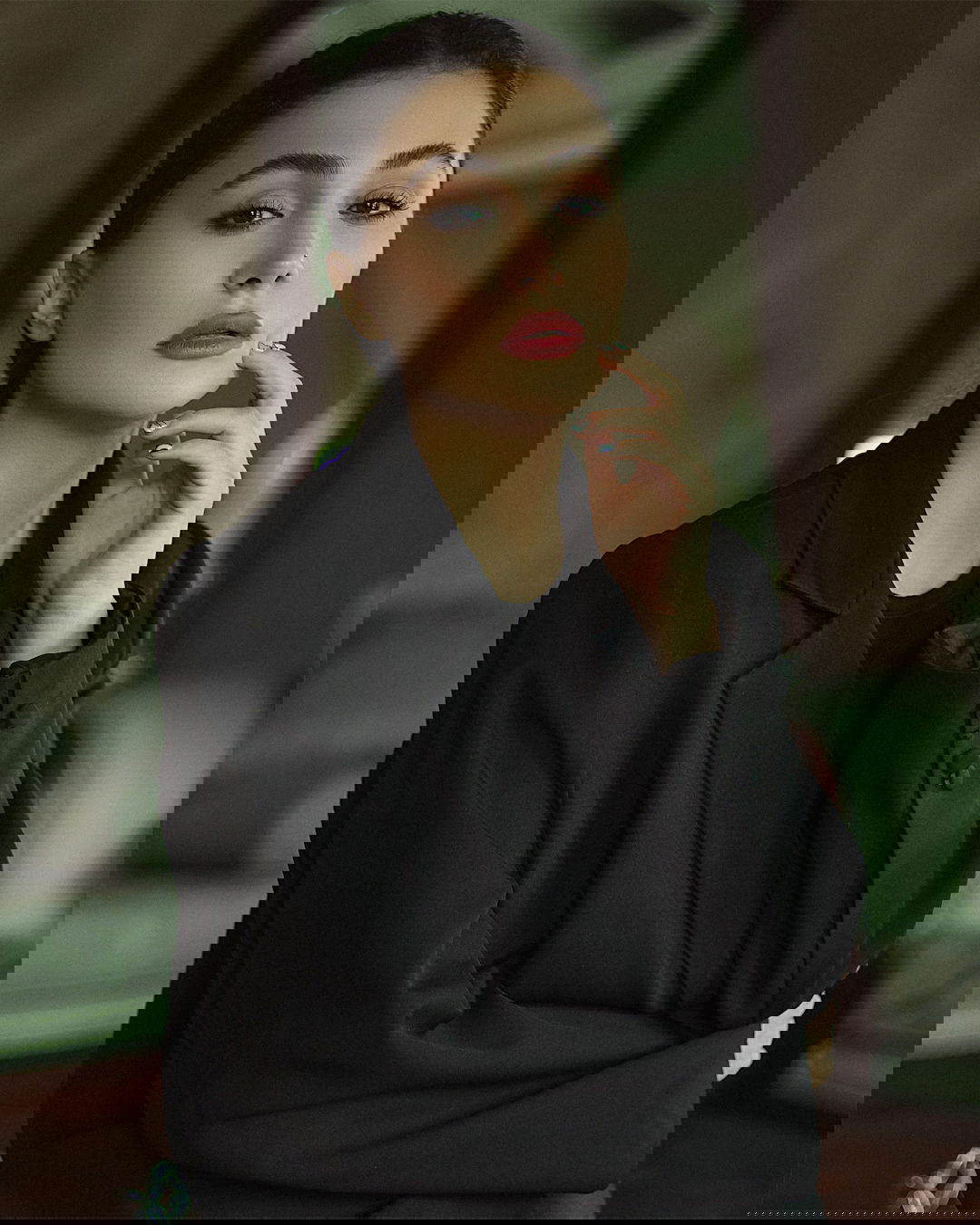 a woman with her hand on her chin